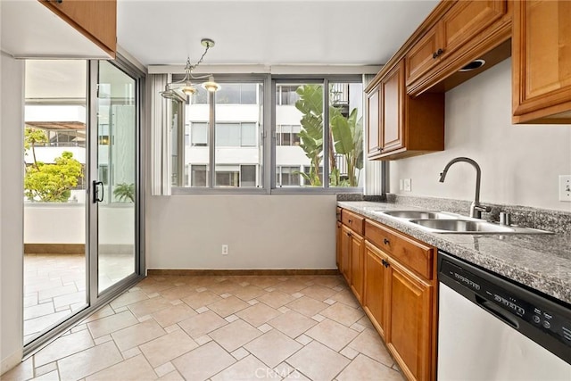 8701 Delgany Ave Unit 105, Playa Del Rey, CA 90293 - kitchen with stainless steel dishwasher, a sink, baseboards, and brown cabinetry