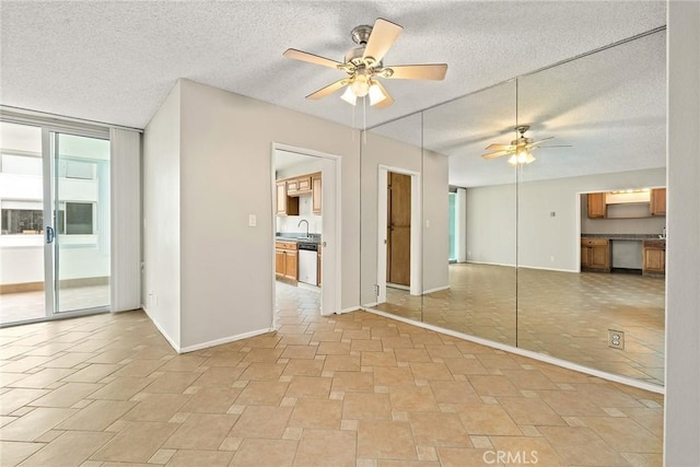 8701 Delgany Ave Unit 105, Playa Del Rey, CA 90293 - unfurnished bedroom with baseboards, a textured ceiling, a sink, a closet, and ceiling fan