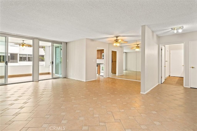 unfurnished living room featuring baseboards, a textured ceiling, and ceiling fan