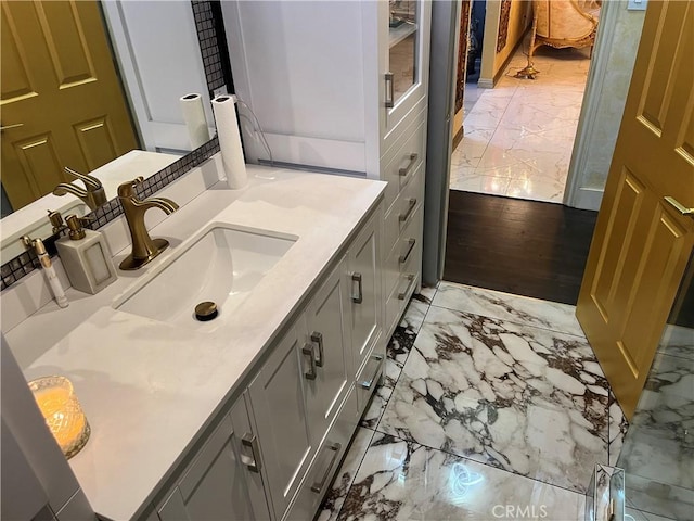 bathroom with vanity and marble finish floor