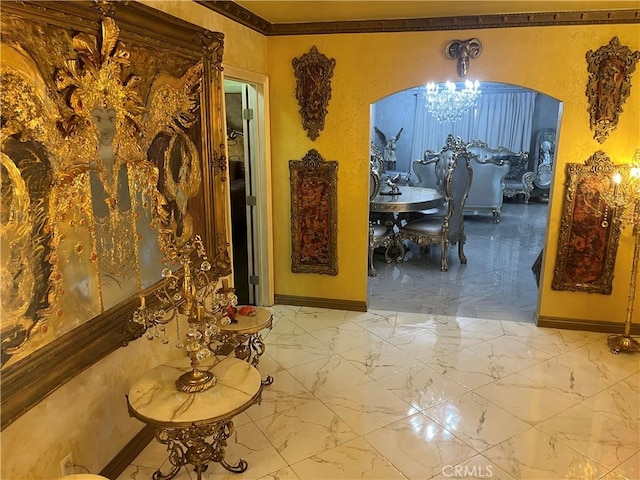 dining area with crown molding, baseboards, a chandelier, arched walkways, and marble finish floor