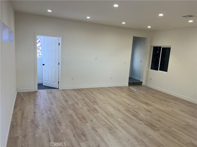 spare room with recessed lighting, visible vents, baseboards, and light wood-style floors