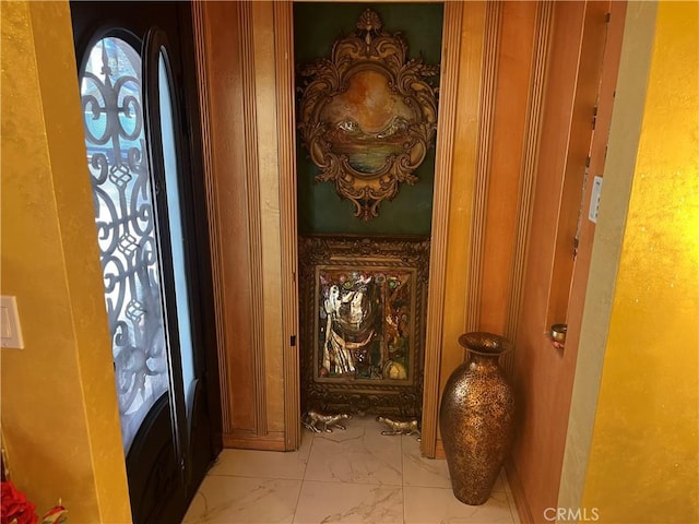 foyer featuring marble finish floor