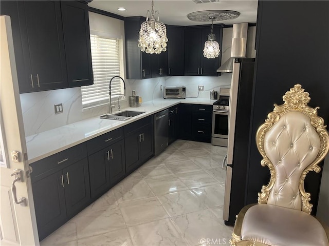 kitchen featuring dishwashing machine, stainless steel range with gas cooktop, a sink, wall chimney range hood, and dark cabinets