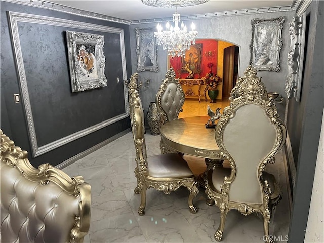 dining space with a chandelier, marble finish floor, and arched walkways