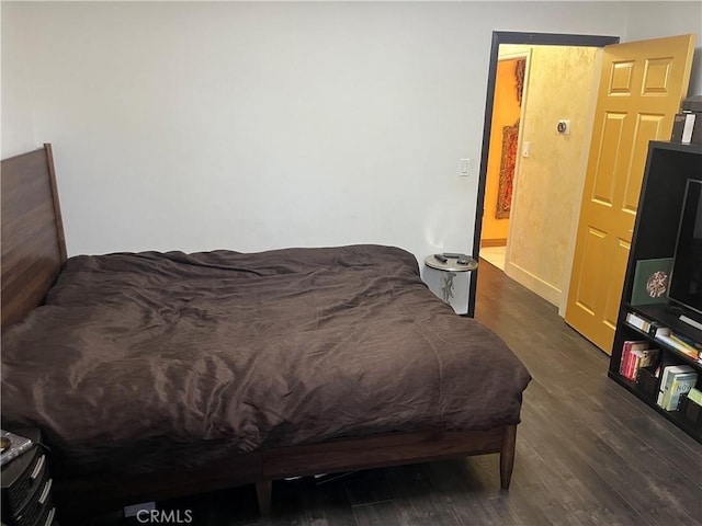 bedroom with wood finished floors