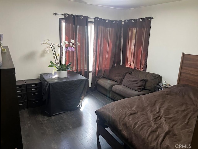 bedroom with dark wood-style floors