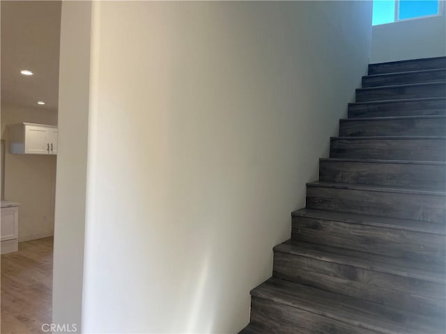 stairway featuring recessed lighting and wood finished floors