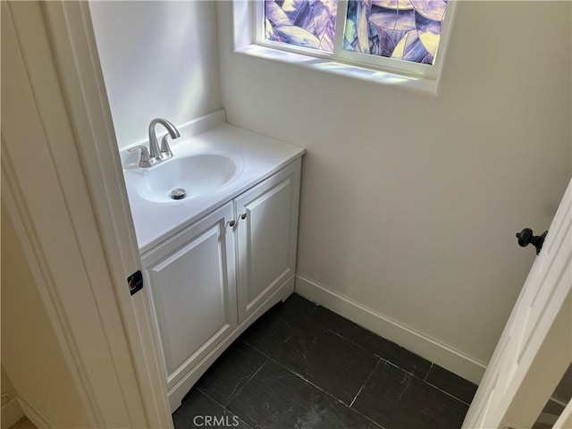 bathroom featuring vanity and baseboards