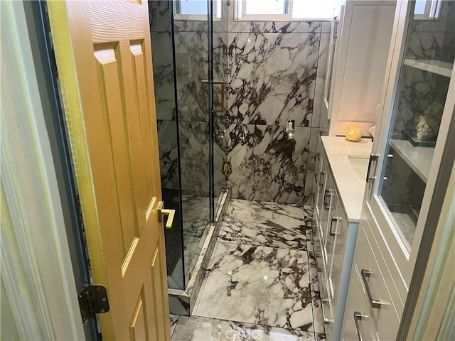 full bathroom featuring a marble finish shower, marble finish floor, and vanity