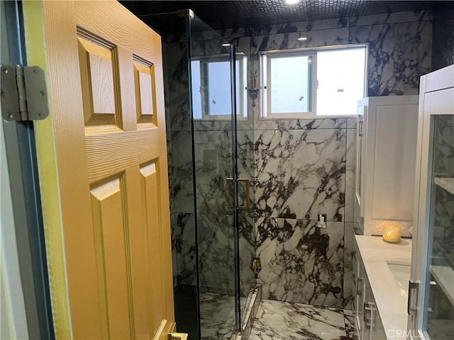 full bath featuring vanity, marble finish floor, and a marble finish shower