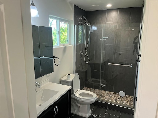 full bathroom with vanity, toilet, and a shower stall