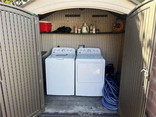 laundry area featuring laundry area, wood finished floors, and independent washer and dryer