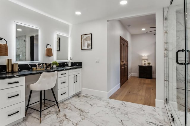 full bath featuring recessed lighting and a marble finish shower