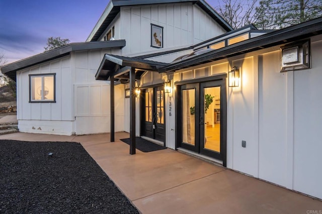 doorway to property with a patio area, french doors, and board and batten siding