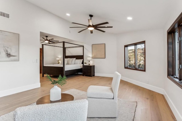 bedroom with visible vents, light wood-style flooring, and baseboards