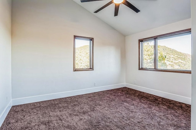 carpeted spare room with baseboards, lofted ceiling, and a ceiling fan