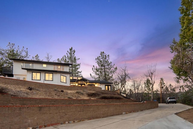 contemporary home with stucco siding and driveway