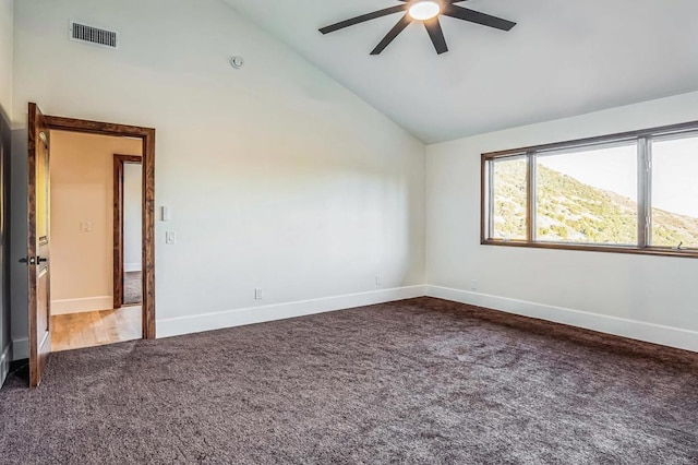 empty room with baseboards, visible vents, high vaulted ceiling, ceiling fan, and carpet flooring