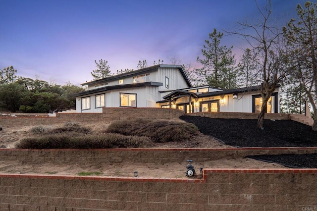 back of property at dusk with board and batten siding