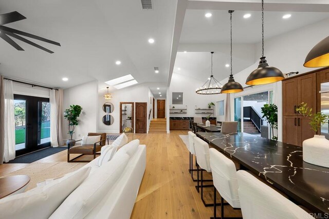 1326 Farmer Rd, Julian, CA 92036 - living area featuring visible vents, vaulted ceiling with skylight, light wood-style floors, recessed lighting, and french doors