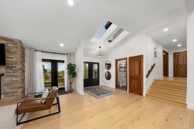 1326 Farmer Rd, Julian, CA 92036 - foyer entrance with stairs, french doors, light wood finished floors, baseboards, and lofted ceiling with skylight