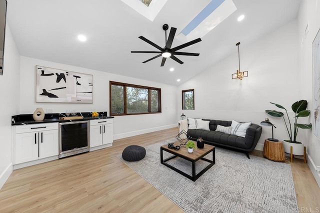 1326 Farmer Rd, Julian, CA 92036 - living area featuring a ceiling fan, beverage cooler, light wood finished floors, baseboards, and lofted ceiling with skylight