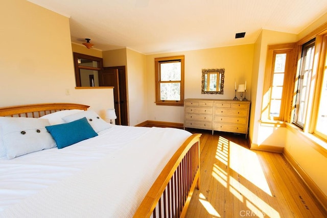 bedroom with baseboards and hardwood / wood-style floors