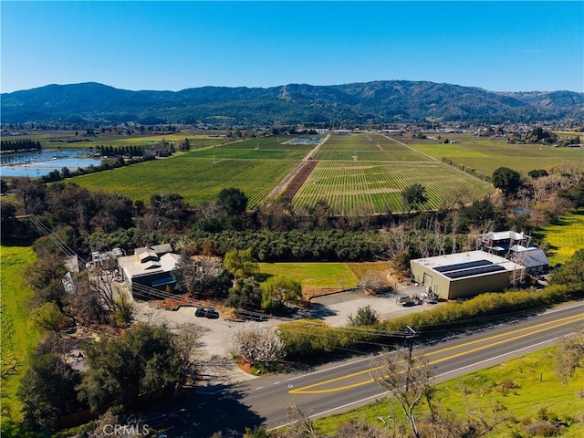 birds eye view of property with a water and mountain view and a rural view