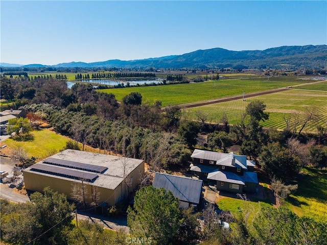 drone / aerial view featuring a water and mountain view