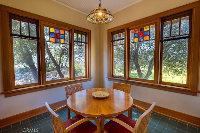 dining area featuring a notable chandelier and baseboards