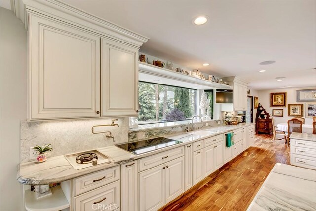 1471 Rosehill, Redlands, CA 92373 - kitchen featuring a sink, light wood-style flooring, decorative backsplash, light stone countertops, and black electric cooktop