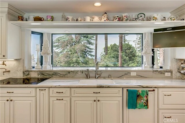 1471 Rosehill, Redlands, CA 92373 - kitchen featuring a sink, backsplash, light stone countertops, and white cabinetry