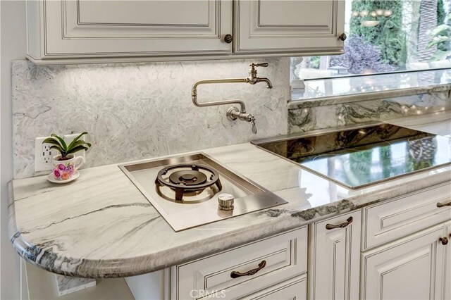 1471 Rosehill, Redlands, CA 92373 - kitchen with stainless steel cooktop, white cabinets, and backsplash