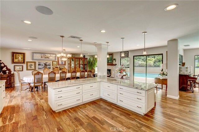 1471 Rosehill, Redlands, CA 92373 - kitchen with light wood-style flooring, recessed lighting, light stone counters, white cabinetry, and decorative light fixtures