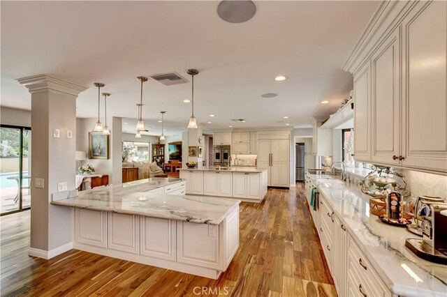 1471 Rosehill, Redlands, CA 92373 - kitchen featuring plenty of natural light, stainless steel appliances, wood finished floors, light stone countertops, and recessed lighting