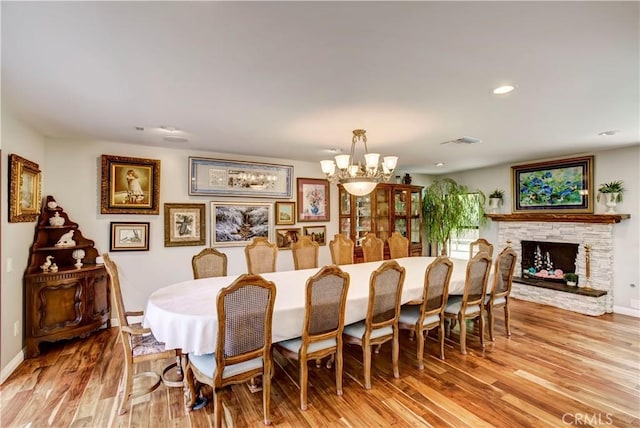 1471 Rosehill, Redlands, CA 92373 - dining area featuring a chandelier, light wood-type flooring, baseboards, recessed lighting, and a stone fireplace