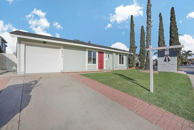 ranch-style home with a garage, concrete driveway, and a front yard