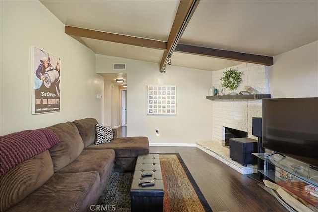 living room featuring visible vents, baseboards, lofted ceiling with beams, a fireplace, and dark wood-style flooring