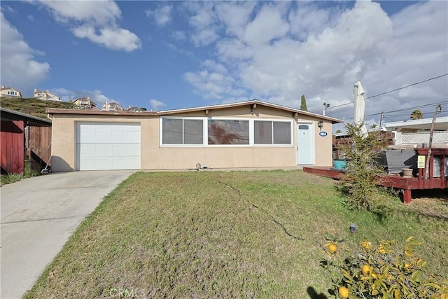 single story home with a front lawn, fence, concrete driveway, stucco siding, and a garage