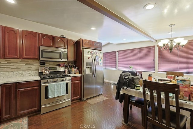 kitchen with beamed ceiling, dark wood-type flooring, tasteful backsplash, stainless steel appliances, and a chandelier