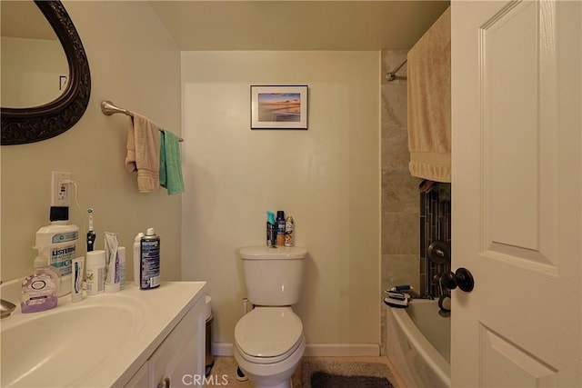 bathroom featuring baseboards, toilet, vanity, and bathing tub / shower combination