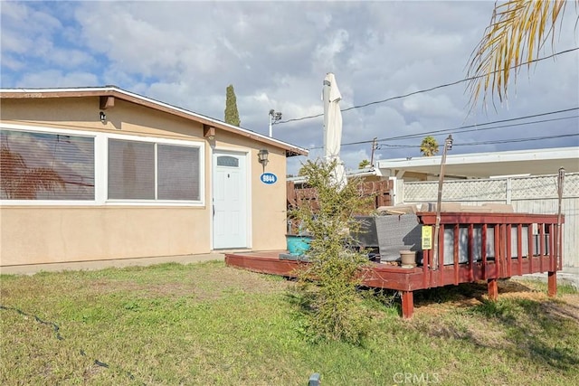 view of yard featuring a wooden deck and fence