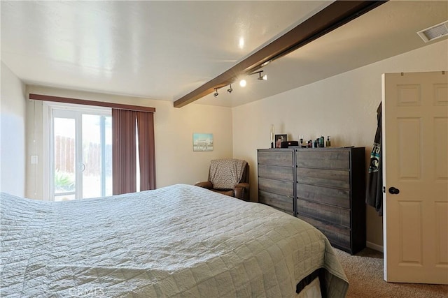 carpeted bedroom featuring visible vents, beamed ceiling, and access to outside