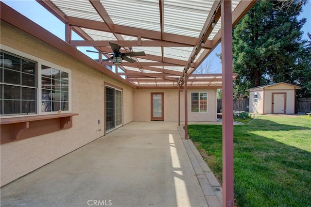 view of patio featuring an outdoor structure, a storage unit, fence, and a pergola