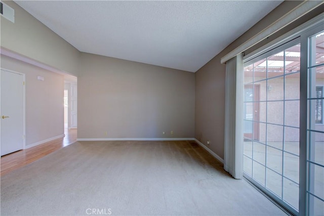 unfurnished room with visible vents, baseboards, carpet, and a textured ceiling