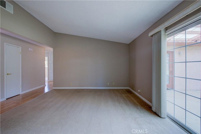 spare room with light carpet, visible vents, and baseboards