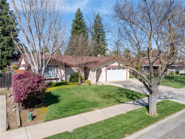 ranch-style home with fence, concrete driveway, a front yard, stucco siding, and an attached garage