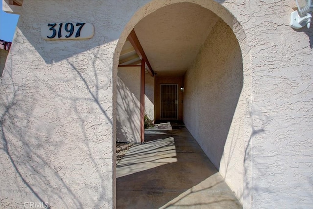 view of exterior entry with stucco siding