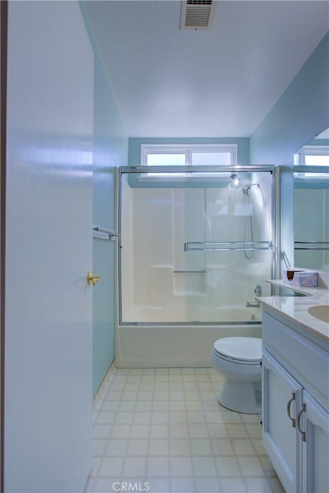 bathroom featuring visible vents, bath / shower combo with glass door, toilet, and vanity